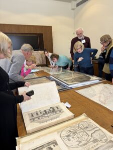 People looking at old maps