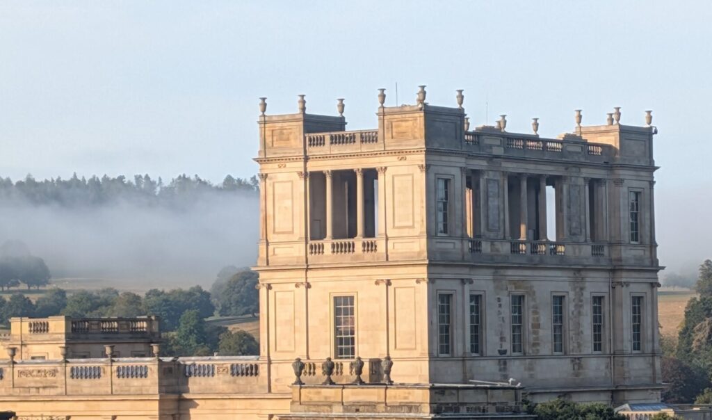 Chatsworth House with mist over the hills behind